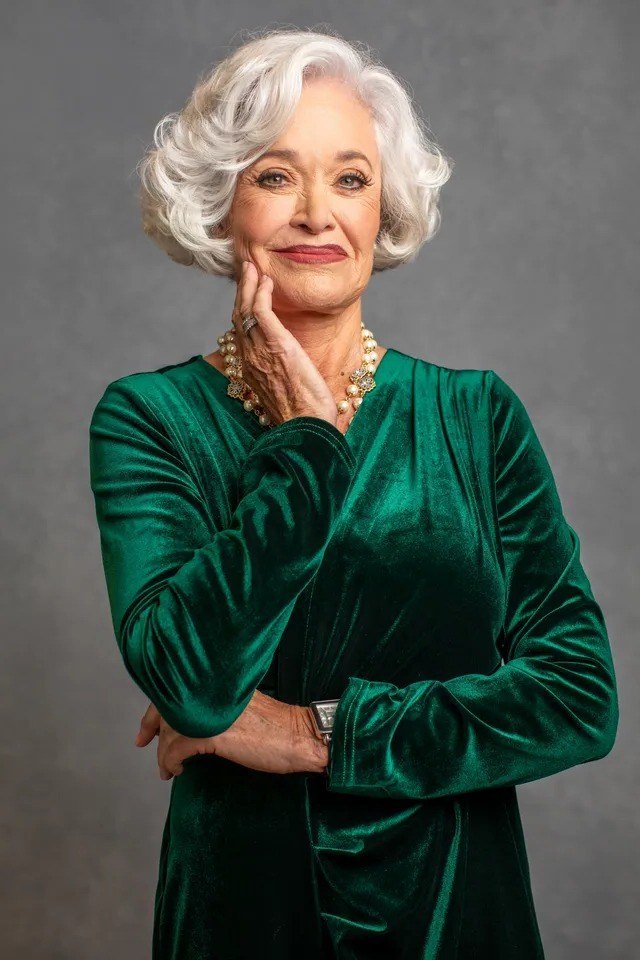 Emerald Green Velvet Wrap Dress worn by older woman, emerald green velvet wrap dress, studio portrait