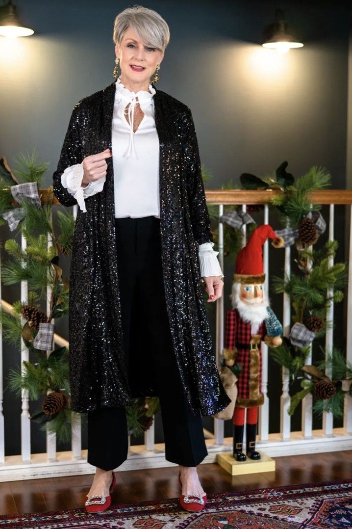 black sequin long cardigan with white top by christmas tree