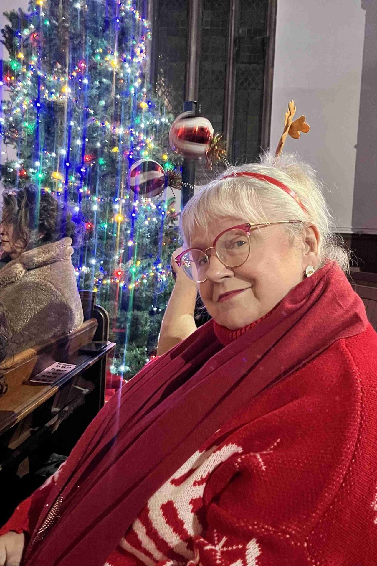 Red Snowflake Sweater at Church worn by older woman, red snowflake sweater at church gathering