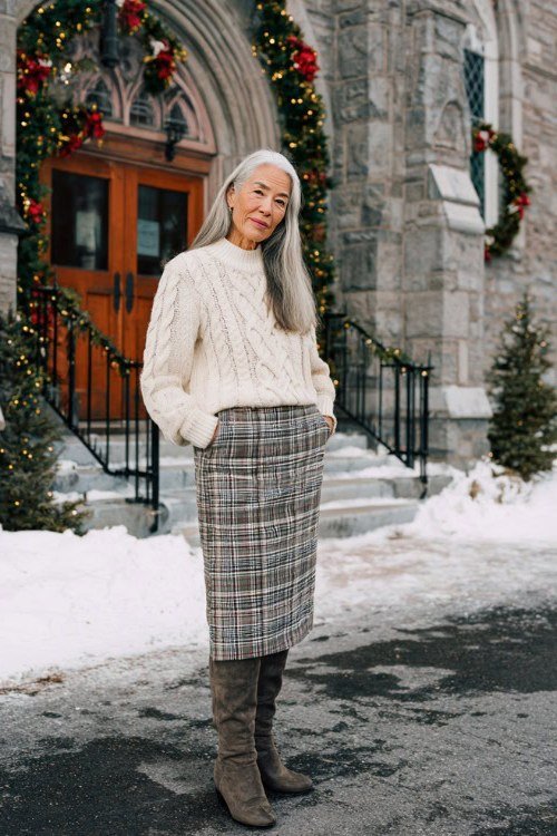 cream cable knit sweater with plaid skirt and boots