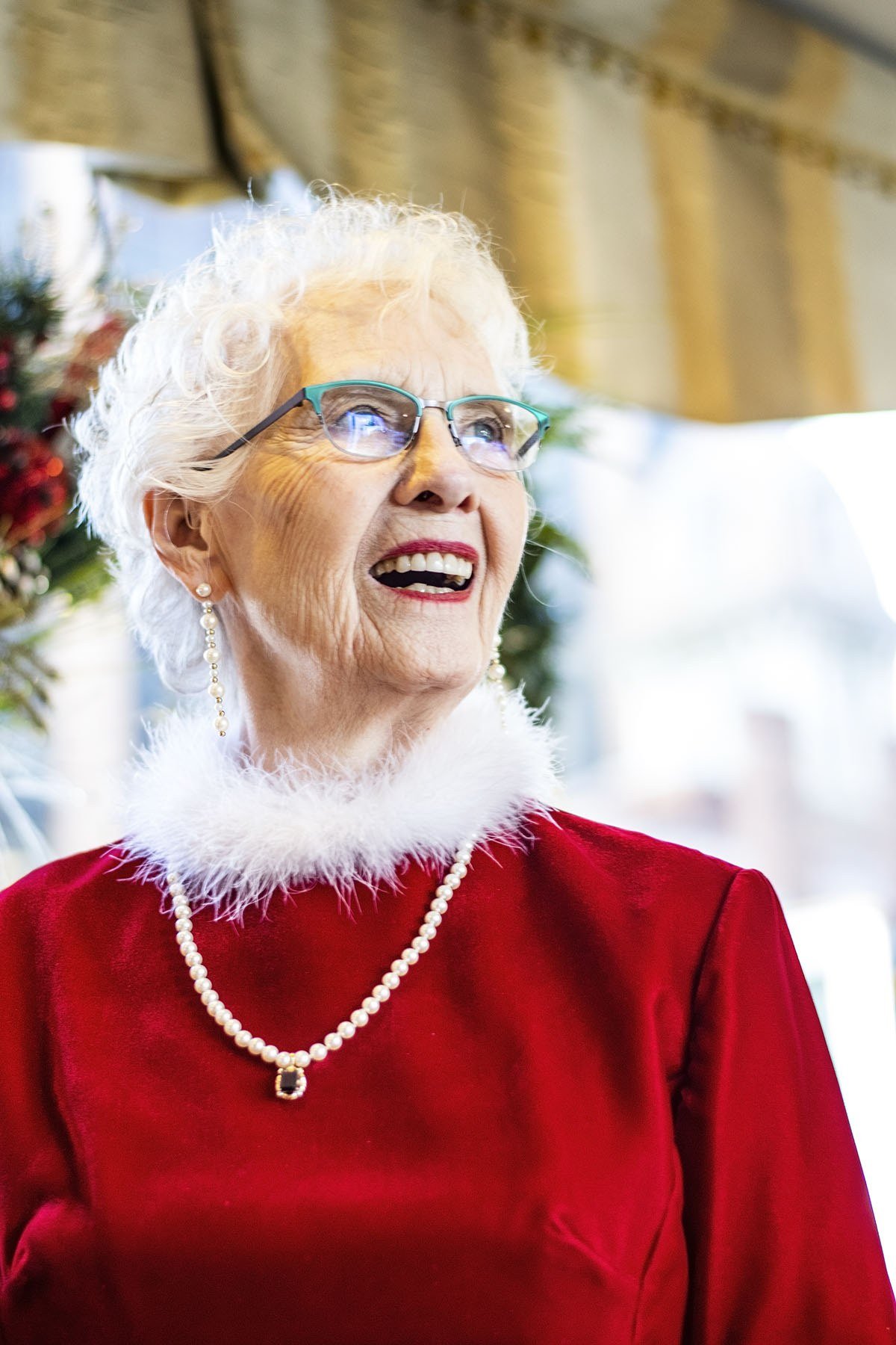 Red velvet top with pearl necklace and white fur collar, festive Christmas outfit for women over 70