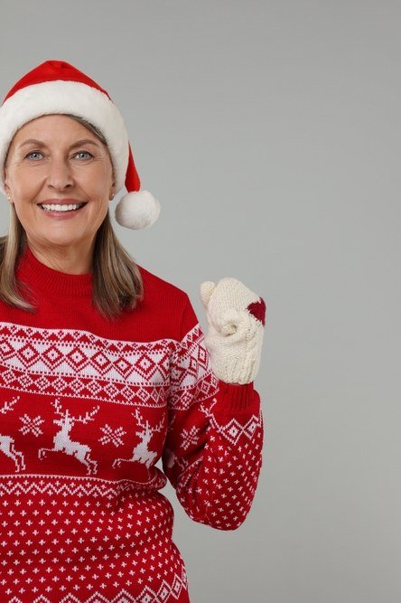 Red reindeer fair isle Christmas sweater with Santa hat and mitten, fun holiday outfit for women over 70