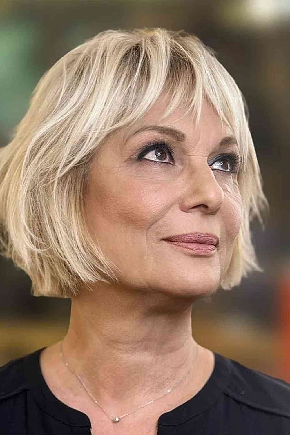 Blonde Shaggy Bob with Bangs, a short hairstyle for women over 50